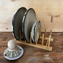 Load image into Gallery viewer, light colored wood plate drying rack with pegs