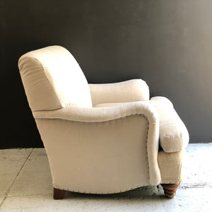 cream colored upholstered lounge chair made with vintage feedback fabric with brown wooden feet