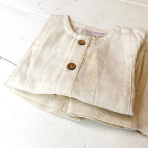 ivory colored shirt and short set, shirt long sleeved with buttons