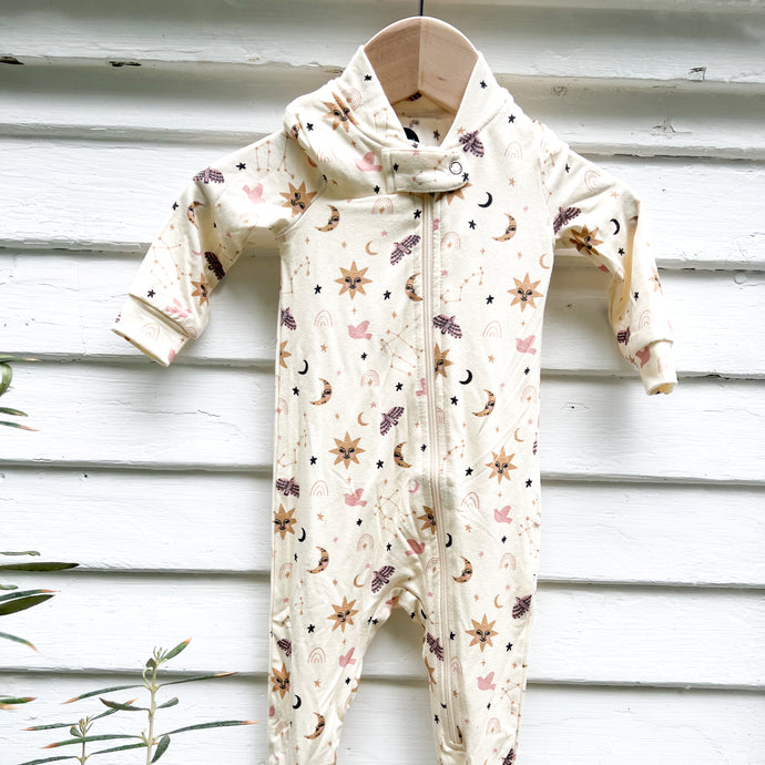 off white one piece zip up pajamas with footies, star, moon and sun pattern