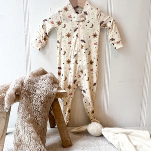 off white one piece zip up pajamas with footies, star, moon and sun pattern