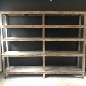 rustic gray toned wood shelving unit with open back and aged wood