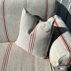 grain sack fabric sofa, natural color with thin red stripes, arm covers, two matching throw pillows and light wood legs