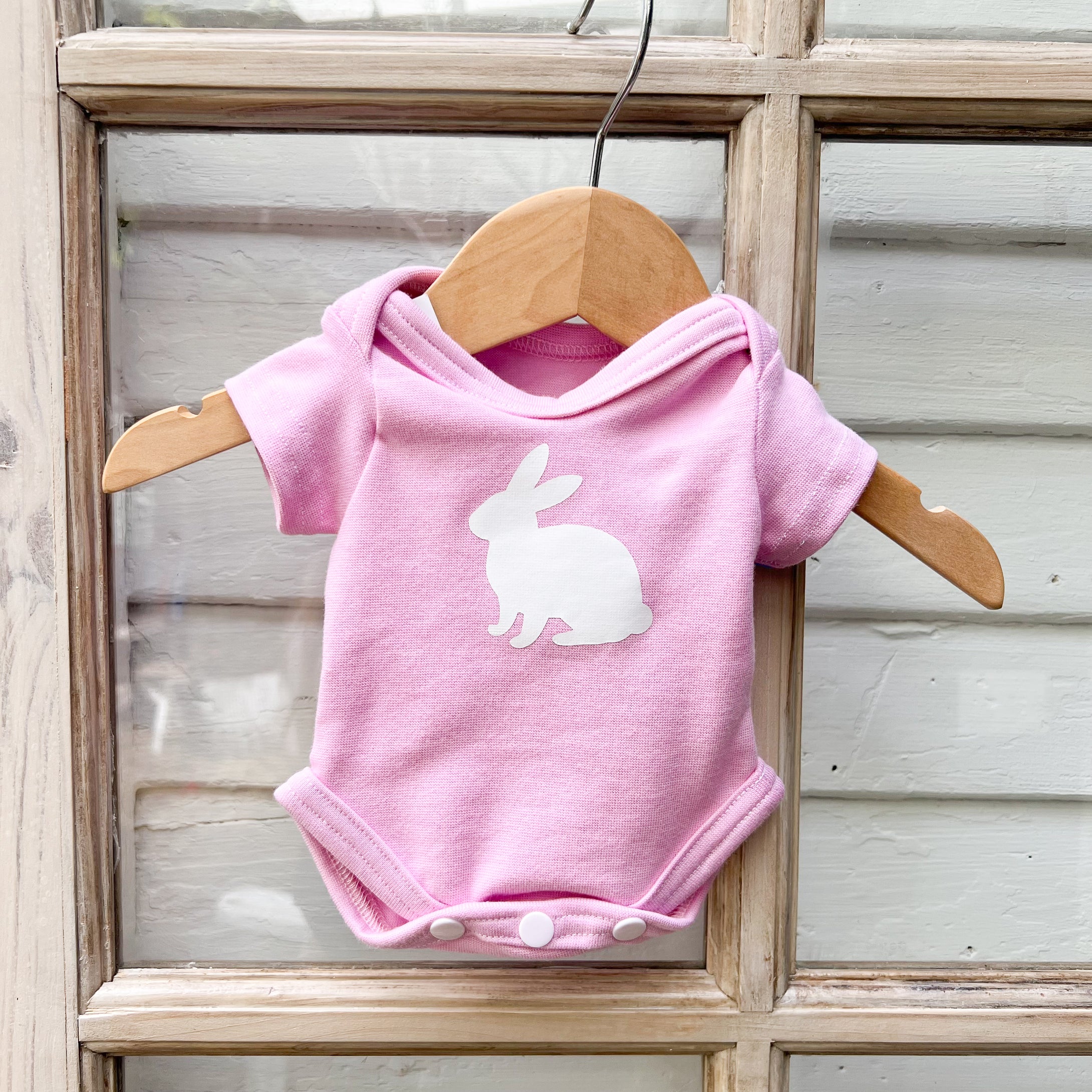 pink short sleeve baby onesie with white bunny on front