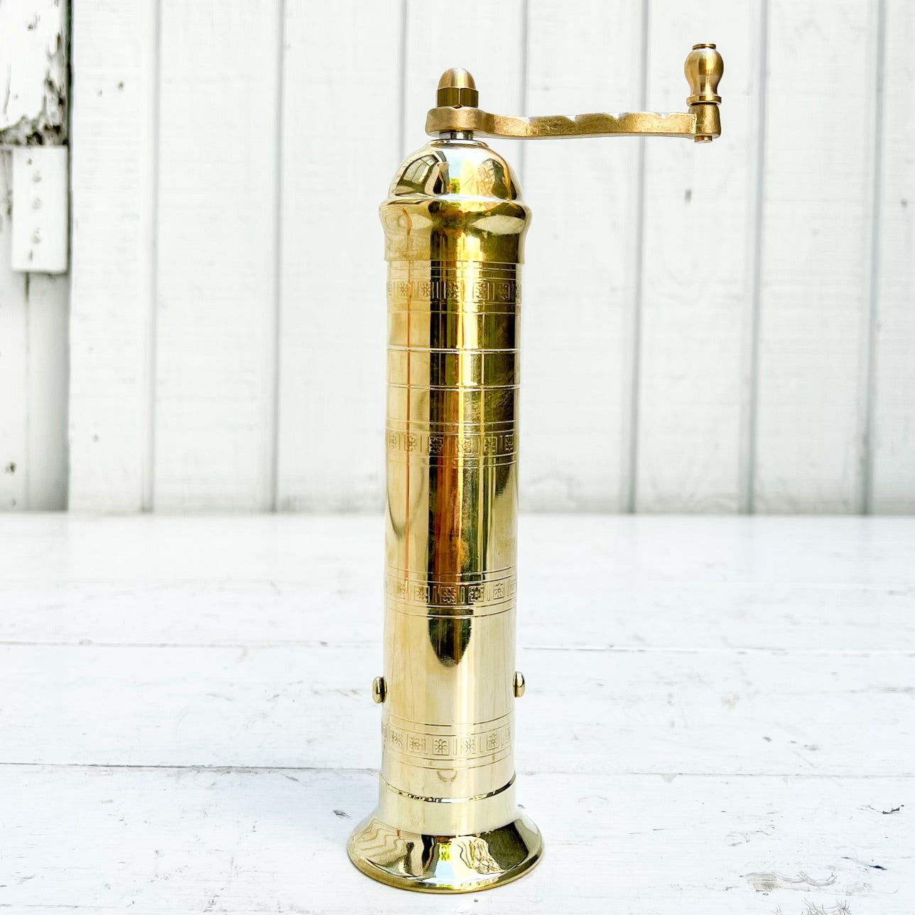 brass salt and pepper grinders with crank handle on the top