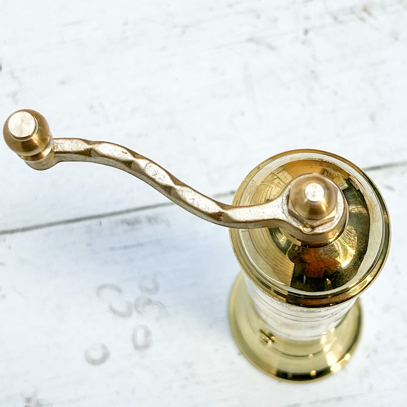 brass salt and pepper grinders with crank handle on the top