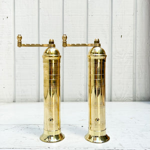 brass salt and pepper grinders with crank handle on the top