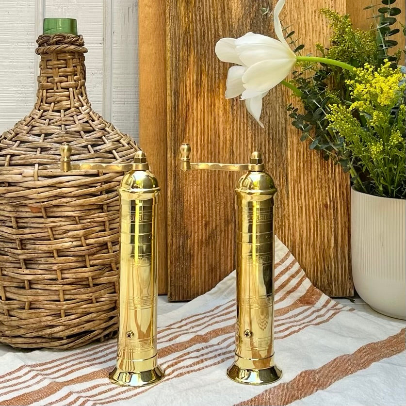 brass salt and pepper grinders with crank handle on the top