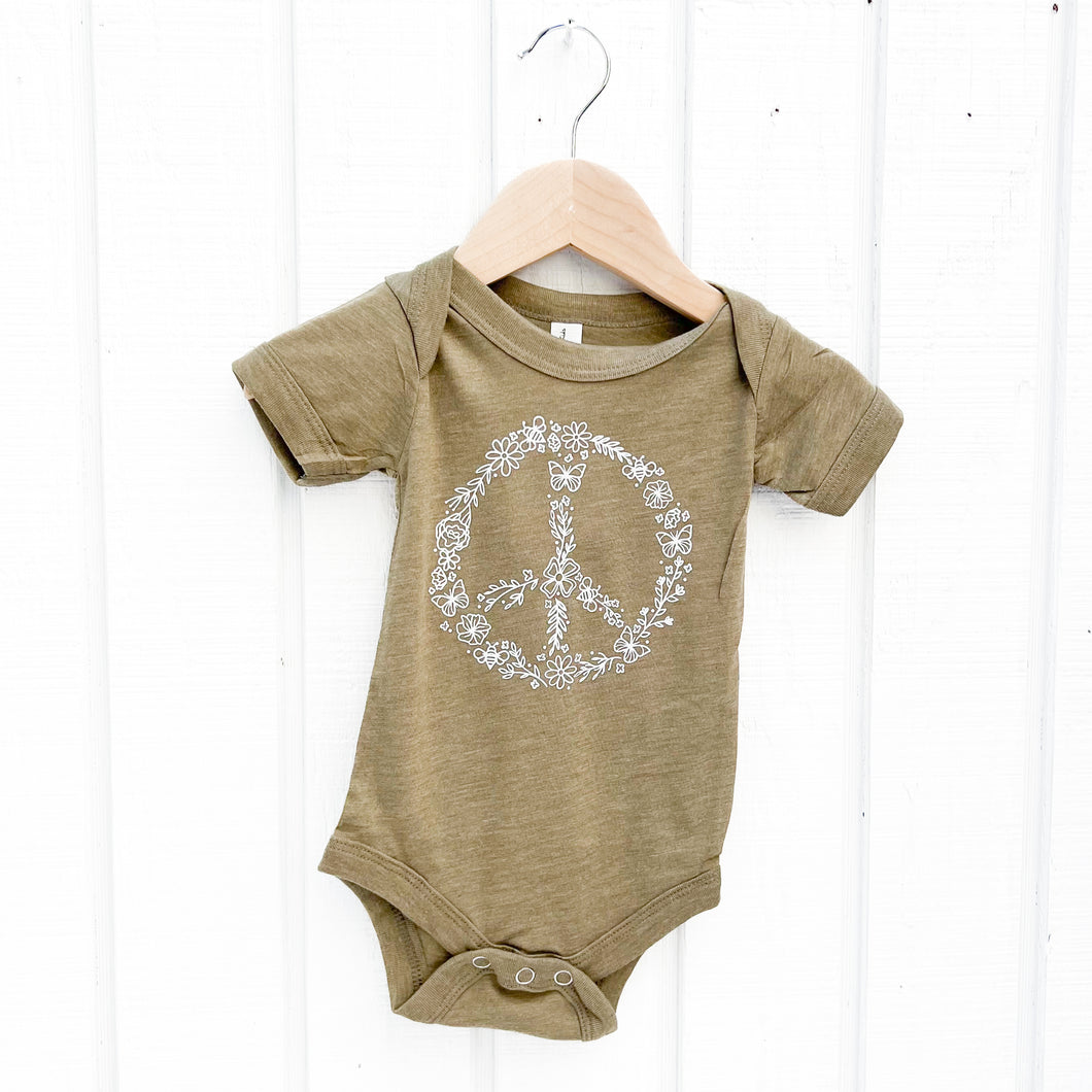 olive green baby onesie with white flower peace sign on front