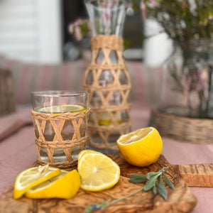 whisky size drinking glass with rattan wrapped on outside