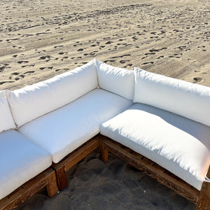 sectional sofa made of repurposed wood, off white cushions with outdoor fabric, medium brown wood color