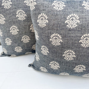 square pillow with pale denim blue-like fabric with white pattern