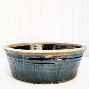 shiny black glazed ceramic bowl with rustic unglazed rim