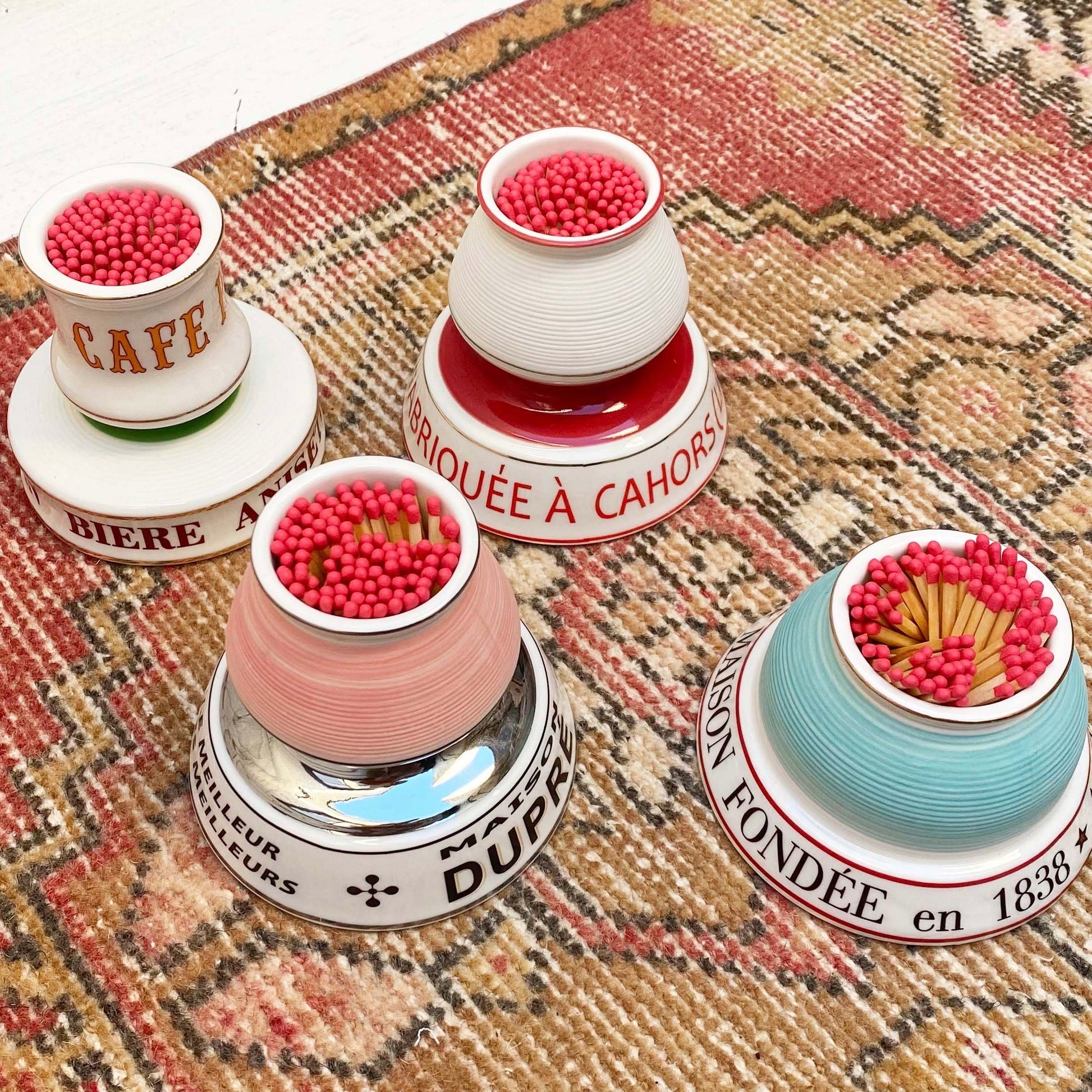 multiple colored ceramic match strike holders with French wording