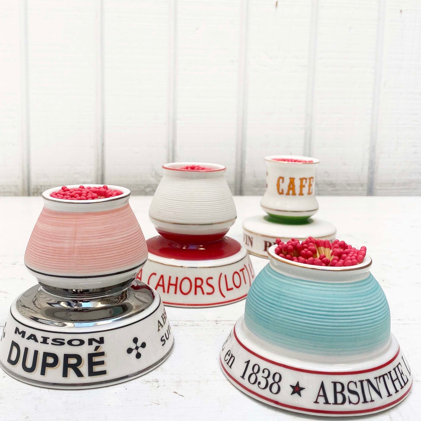 multiple colored ceramic match strike holders with French wording