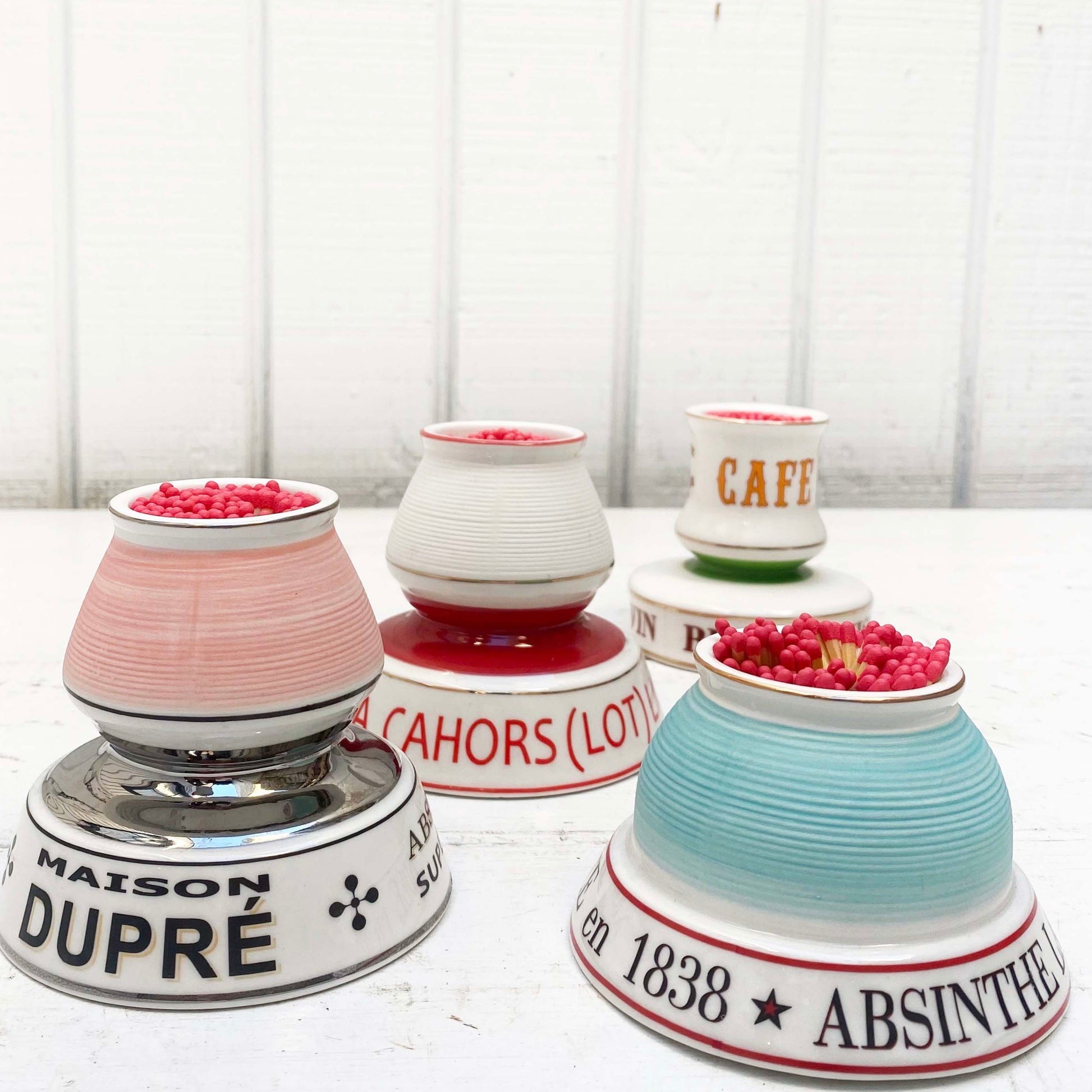 multiple colored ceramic match strike holders with French wording