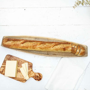 long wooden board used to serve baguettes