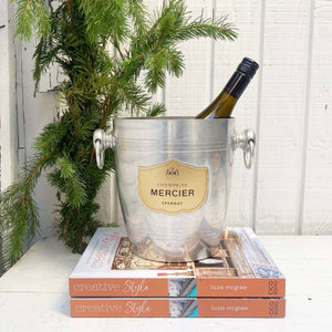 silver ice bucket with brass plaque on front and French words