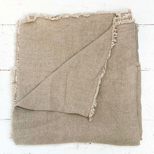 natural colored linen throw blanket with rustic frayed edges