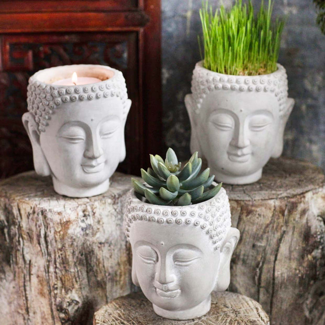 stone planter shaped like a Buddha head