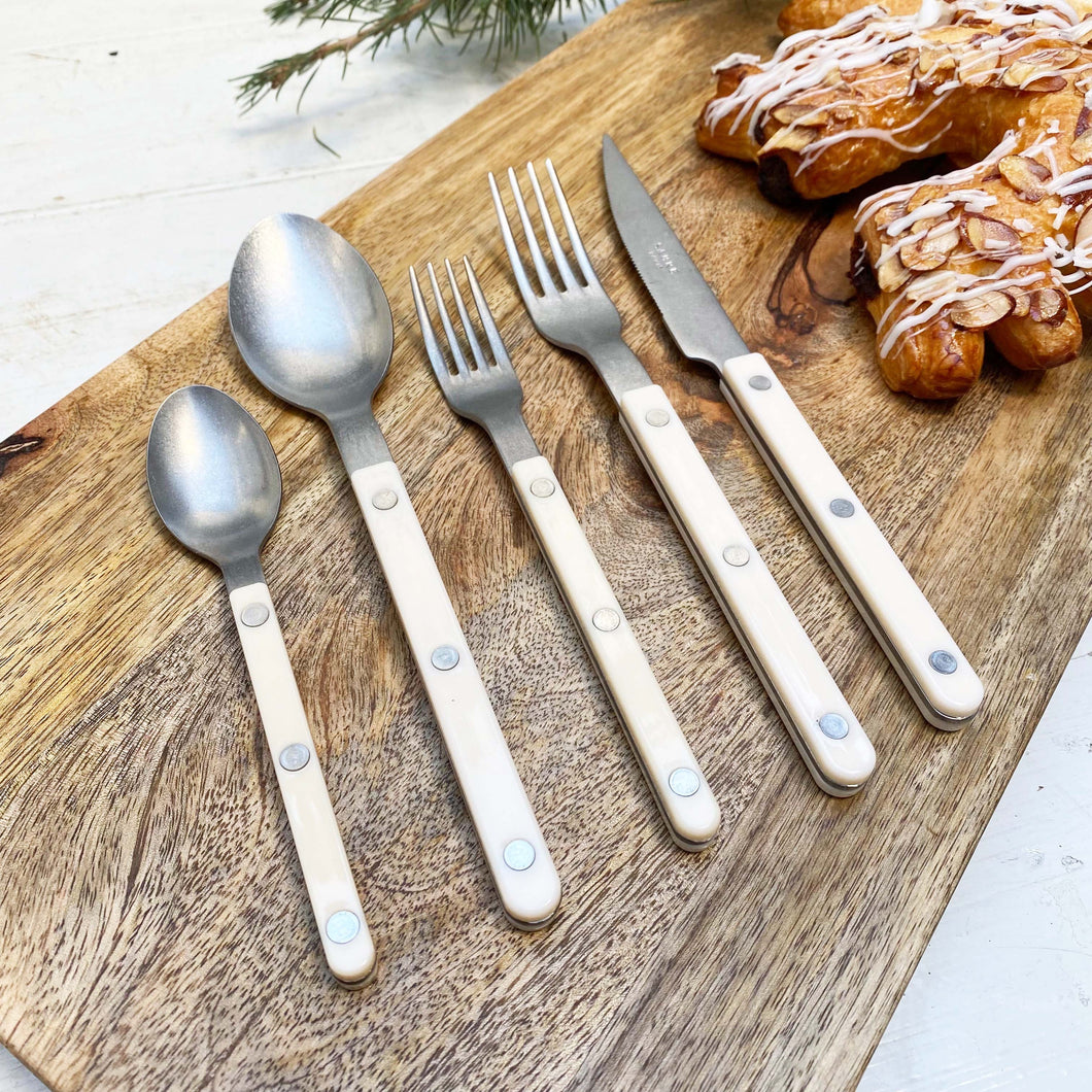two forks, two spoons and a knife with ivory colored handles