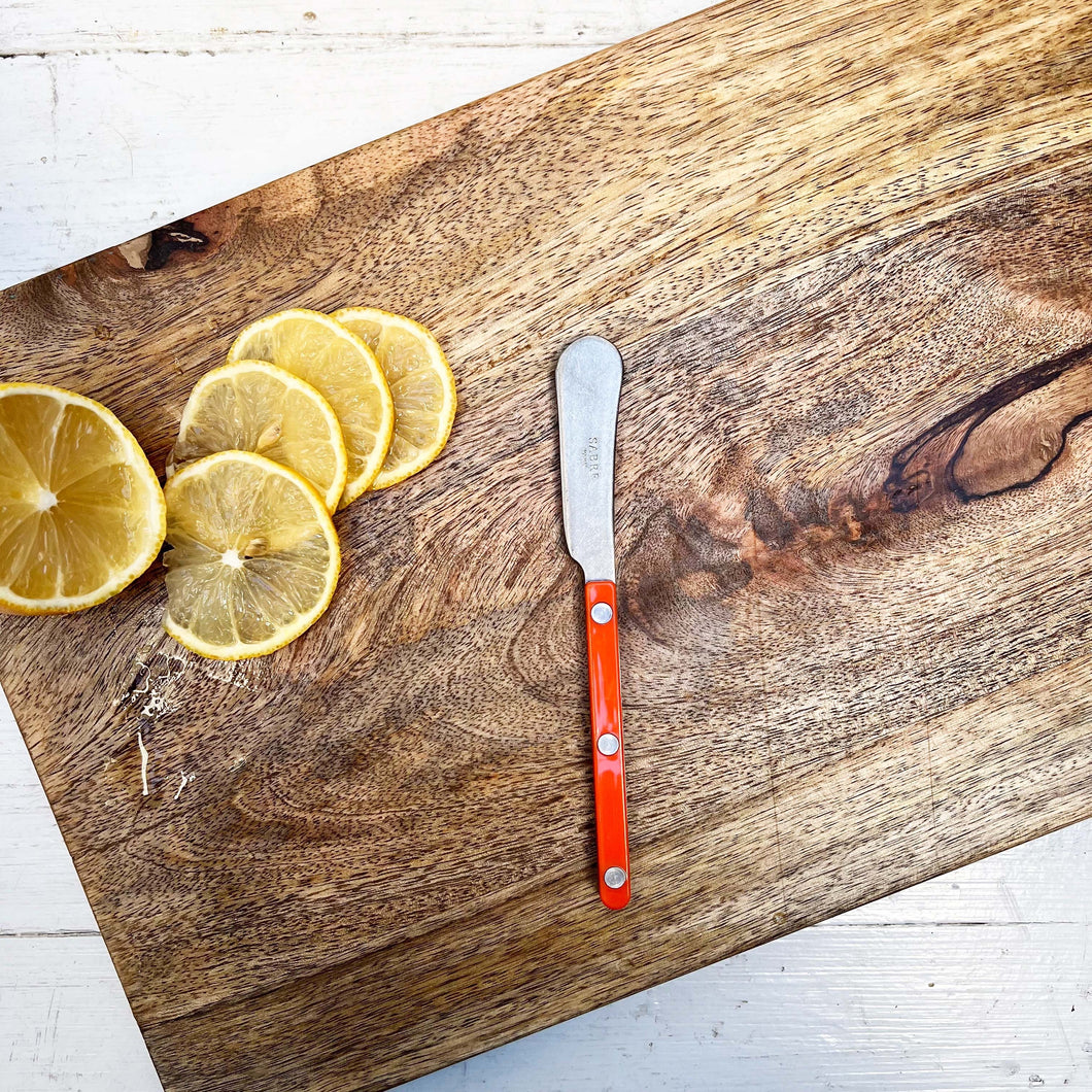 small spreading knife with orange handle