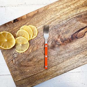 small serving fork with orange handle