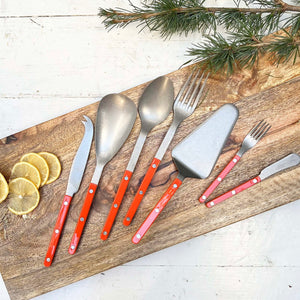 serving utensils with orange handles