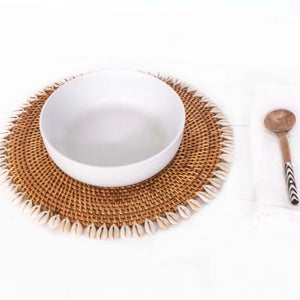 brown rattan round placemat with off white shells on edges