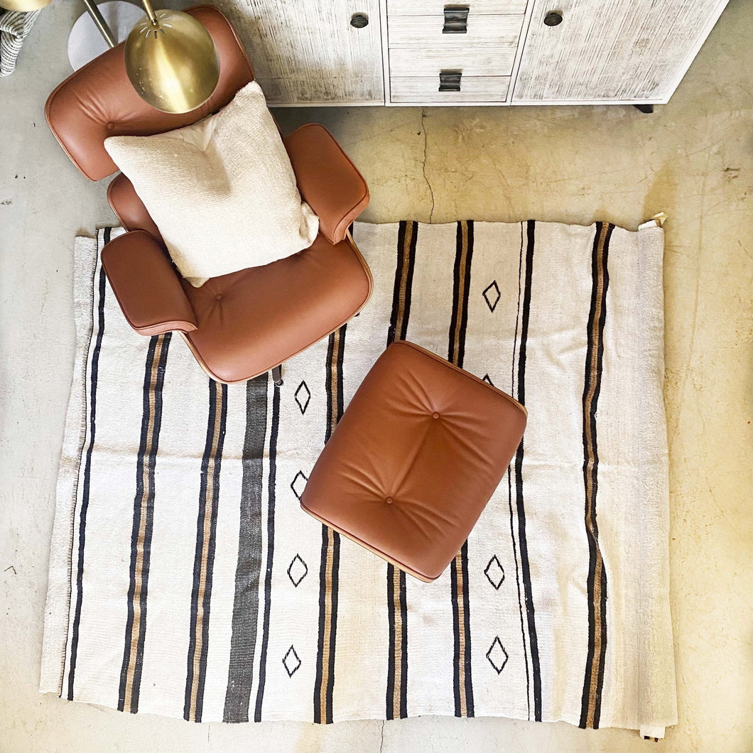 cream colored hemp rug with tan and black stripes and black diamonds 