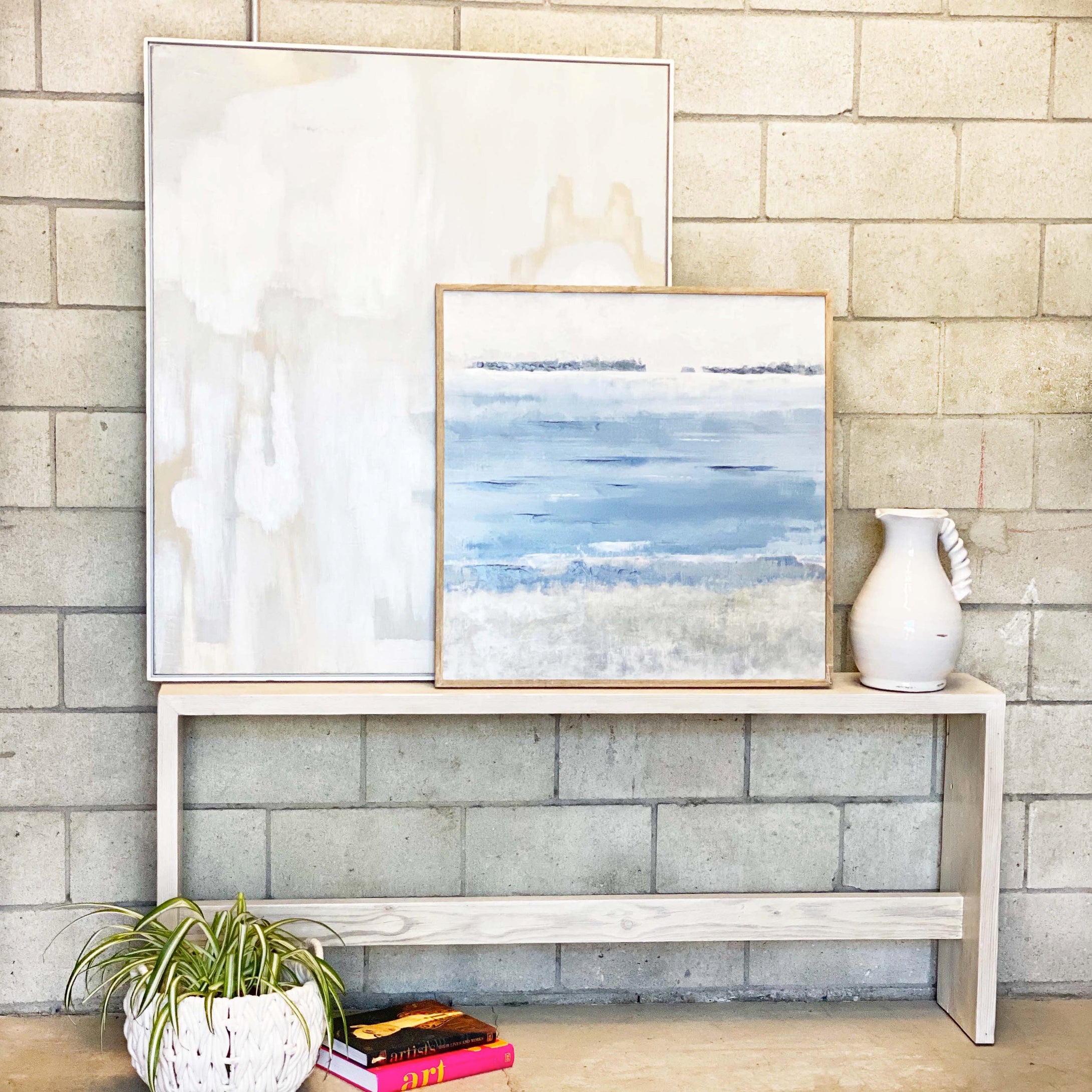 clean line bleached wooden entryway table with bar along bottom