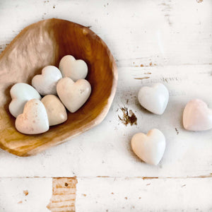 light colored heart shaped stones with inspirational words