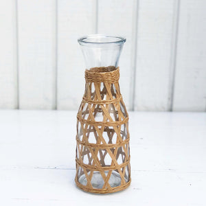 glass carafe covered with rattan