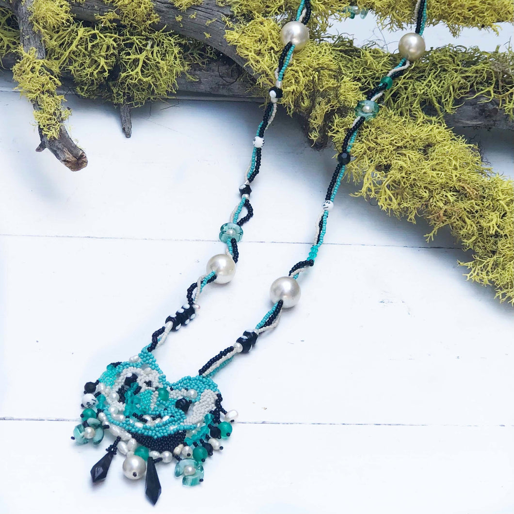 handmade black, white and turquoise beaded necklace with centerpiece