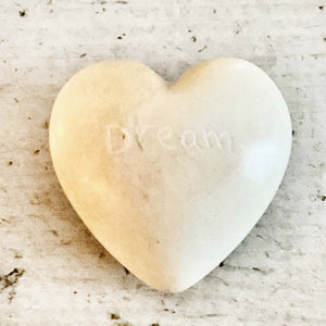 light colored heart shaped stones with inspirational words