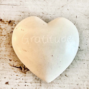 light colored heart shaped stones with inspirational words