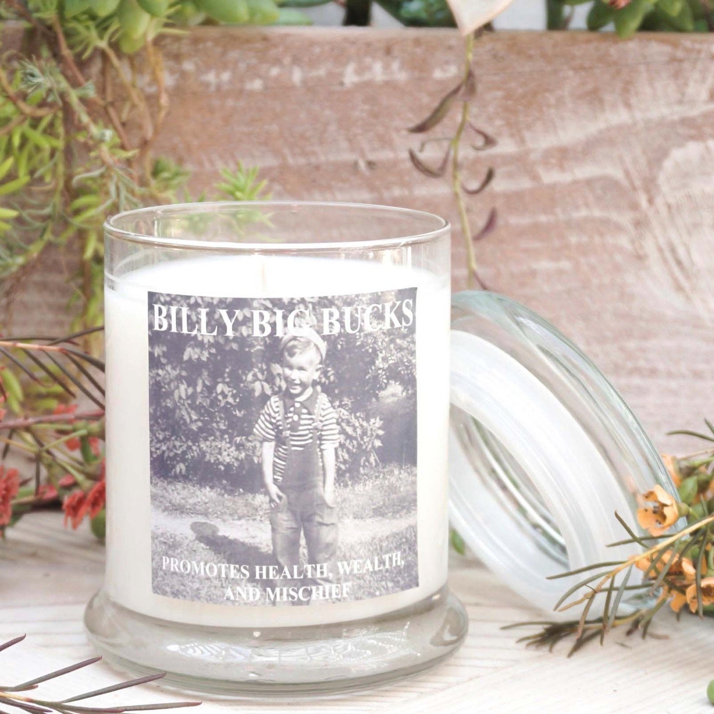 clear glass candle with lid and vintage black and white photo of little boy on label