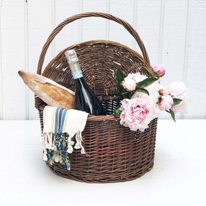 brown wicker picnic basket with top and handle