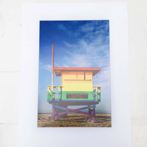 photo of a beach lifeguard station painted in rainbow colors