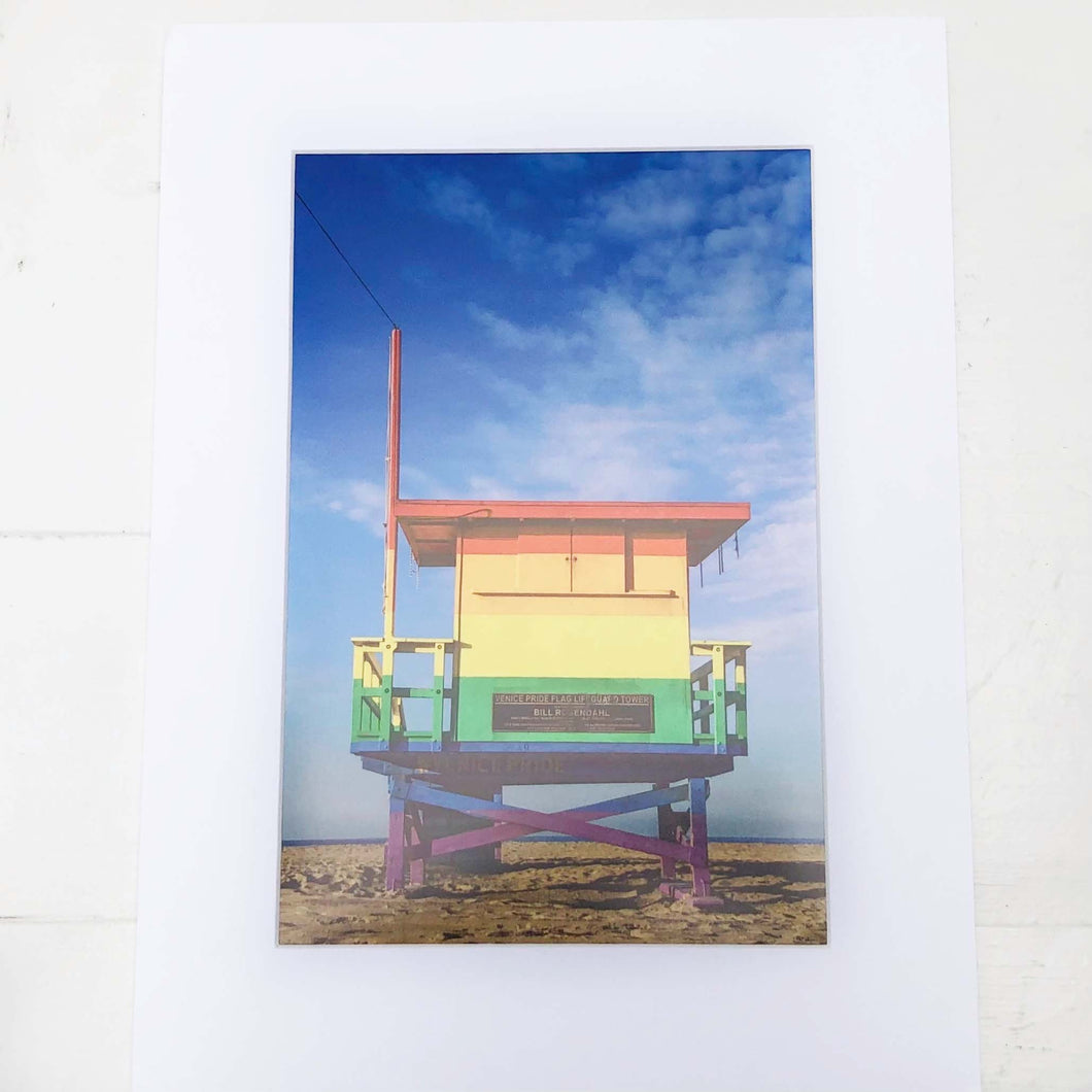 photo of a beach lifeguard station painted in rainbow colors