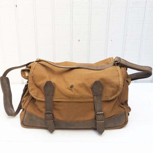 bags made from vintage military canvas, varying colors of army green, khaki and browns with dark leather straps