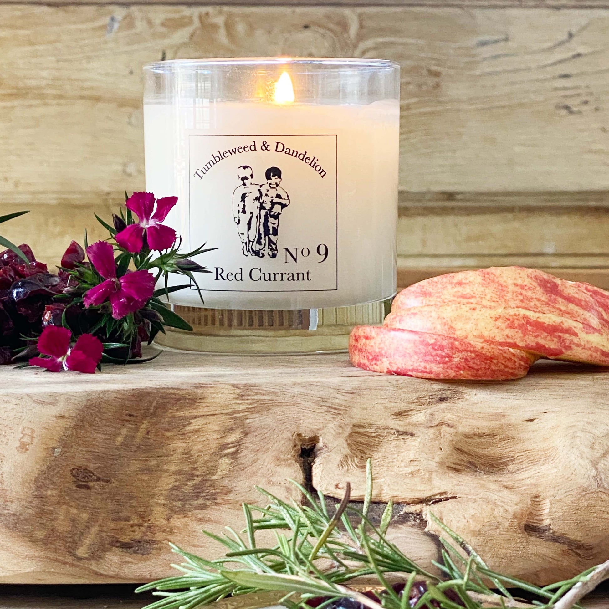 red currant scented candle in clear glass with black logo