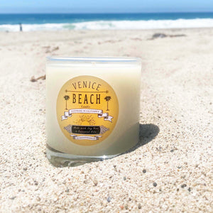 Clear glass candle with tan and black Venice Beach label