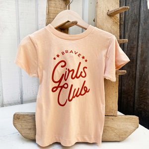pale peach colored children's tee with words"brave girl's club"