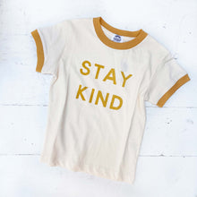Load image into Gallery viewer, cream colored kid&#39;s tee shirt with amber accent around neck and sleeves with words &quot;stay kind&quot; on front