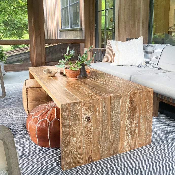 wood coffee table made of repurposed wood stained in medium brown color, open underneath...