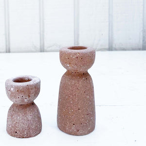 terra cotta colored hour glass shaped concrete taper candle holder