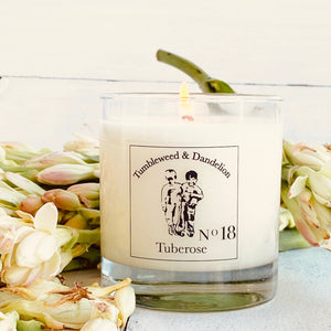 tuberose scented clear glass candle with Tumbleweed and Dandelion logo in black
