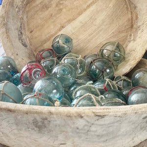 round green/blue glass balls, some with rope around them