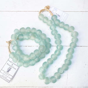pale green glass beads on a strand of jute